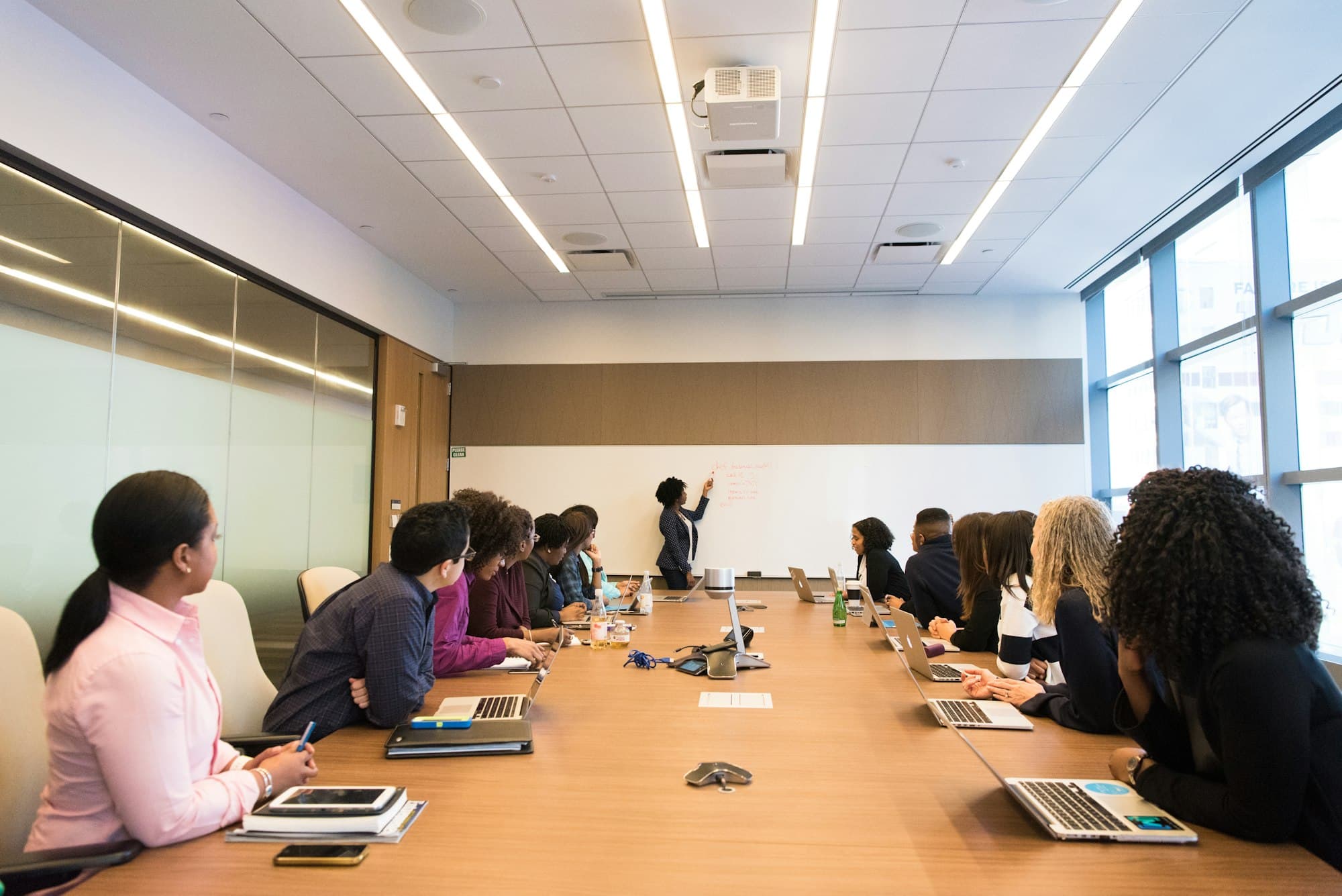 A panel presenting a case analysis to a seated group around a conference table